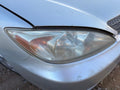 Used Right Headlight Assembly fits: 2002 Toyota Camry R. LE chrome tri